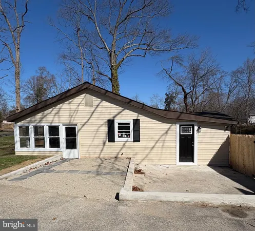 a view of house with backyard space and porch