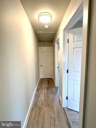 a view of a hallway with wooden floor