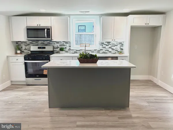 a kitchen with stainless steel appliances a stove refrigerator and a stove top oven