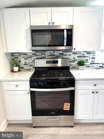 a kitchen with a stove and a microwave