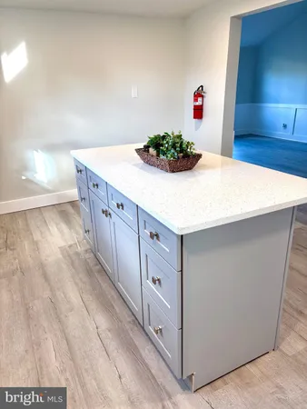 a kitchen with cabinets and wooden floor