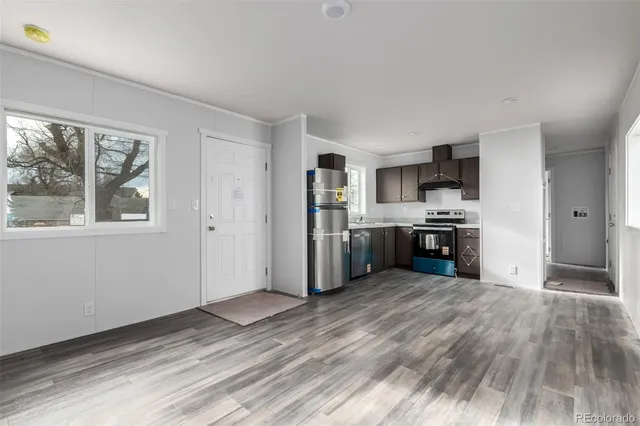 a kitchen with stainless steel appliances granite countertop a refrigerator stove and sink