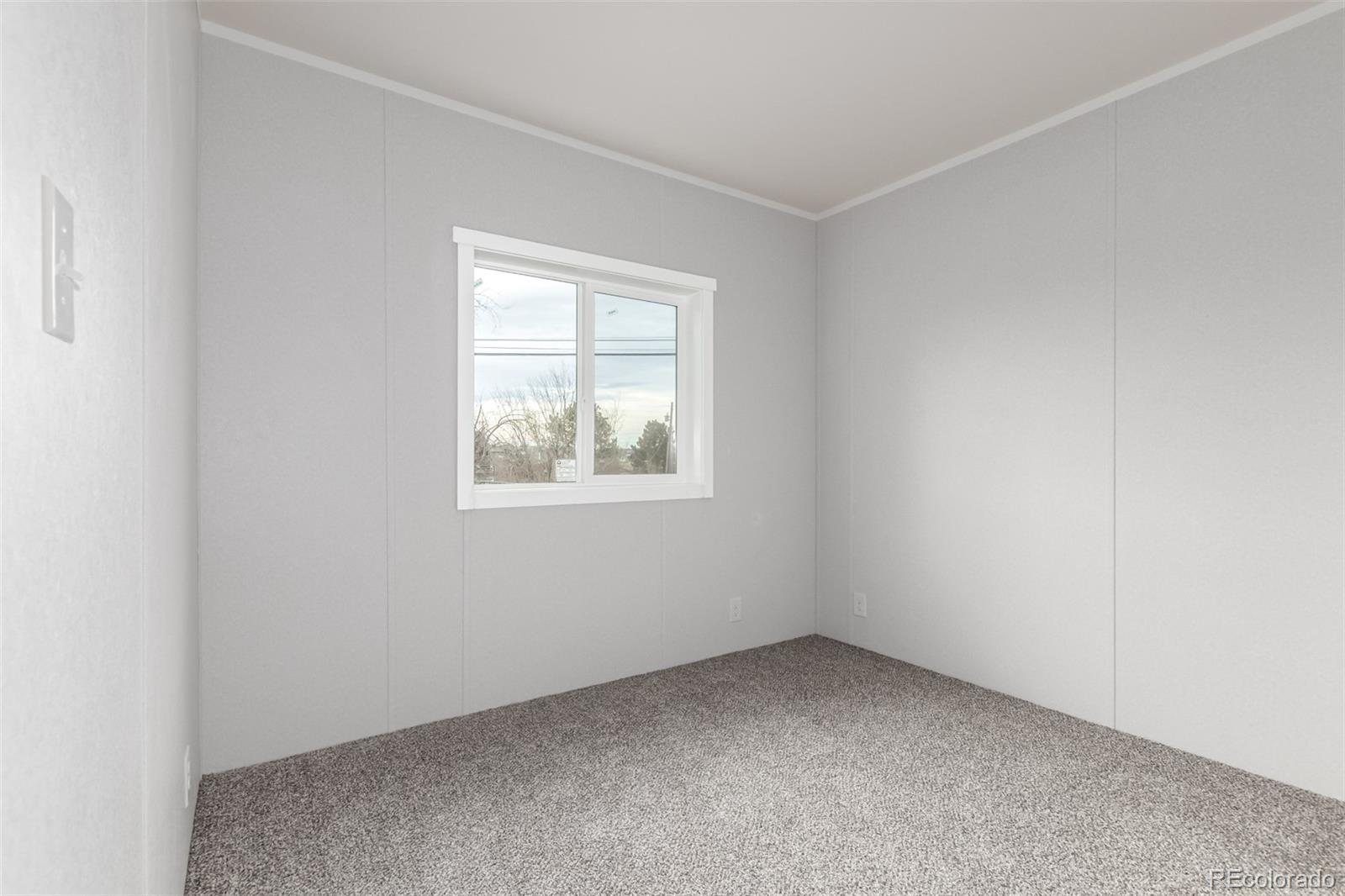 105 Longs Street Brighton, CO 80601 - Photo 12 of 27 an empty room with a window