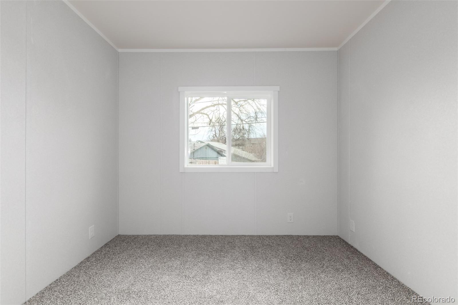 105 Longs Street Brighton, CO 80601 - Photo 13 of 27 an empty room with a window