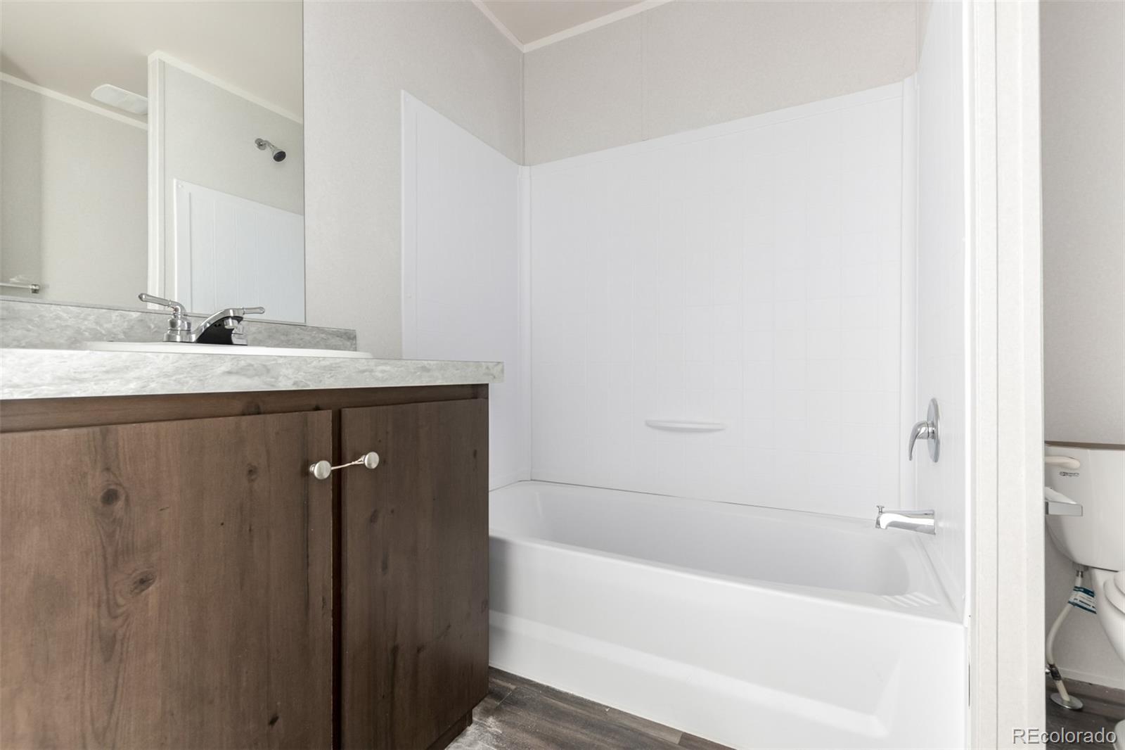 105 Longs Street Brighton, CO 80601 - Photo 15 of 27 a bathroom with a bathtub and a sink