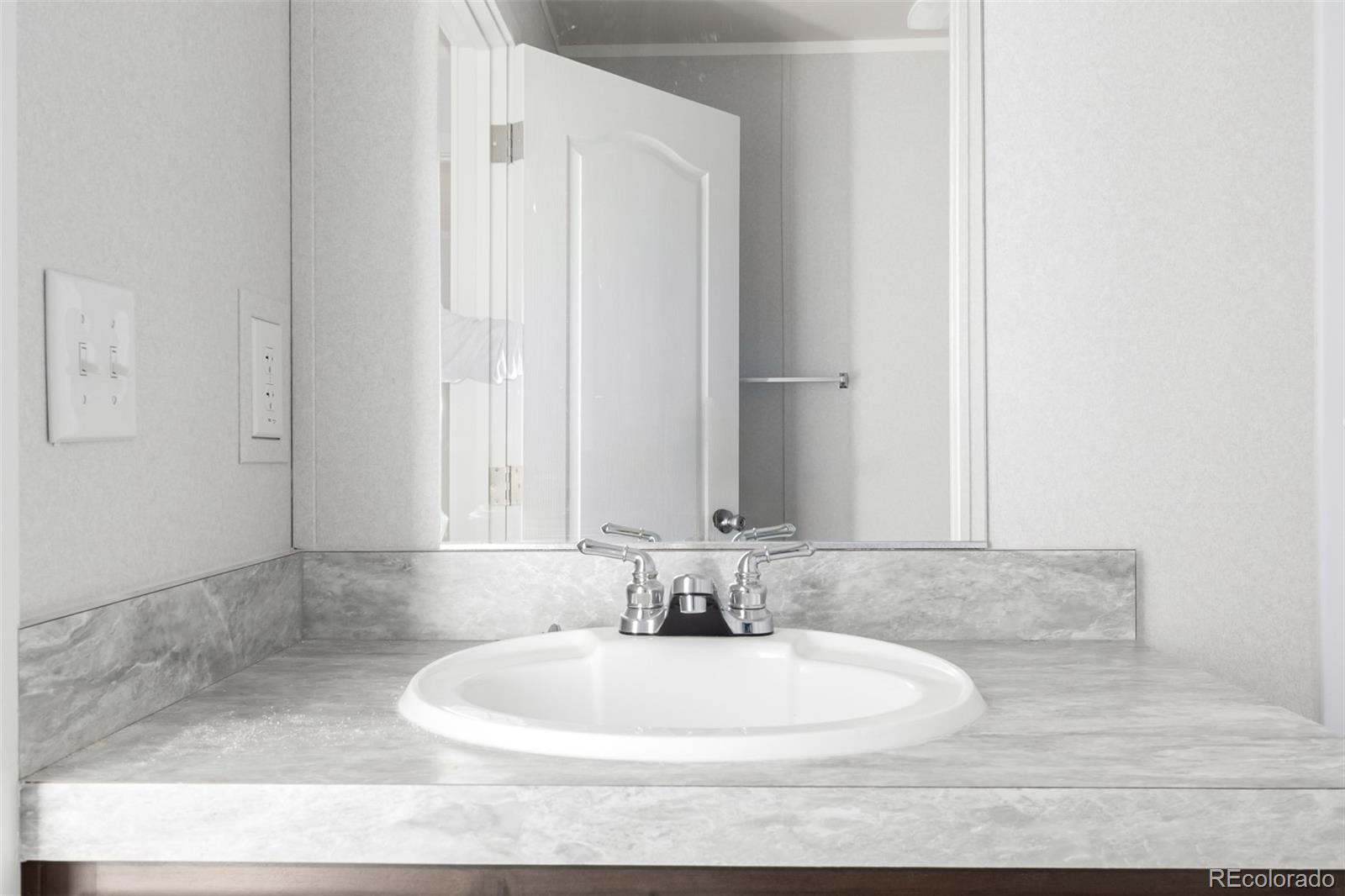 105 Longs Street Brighton, CO 80601 - Photo 16 of 27 a bathroom with a bathtub and shower