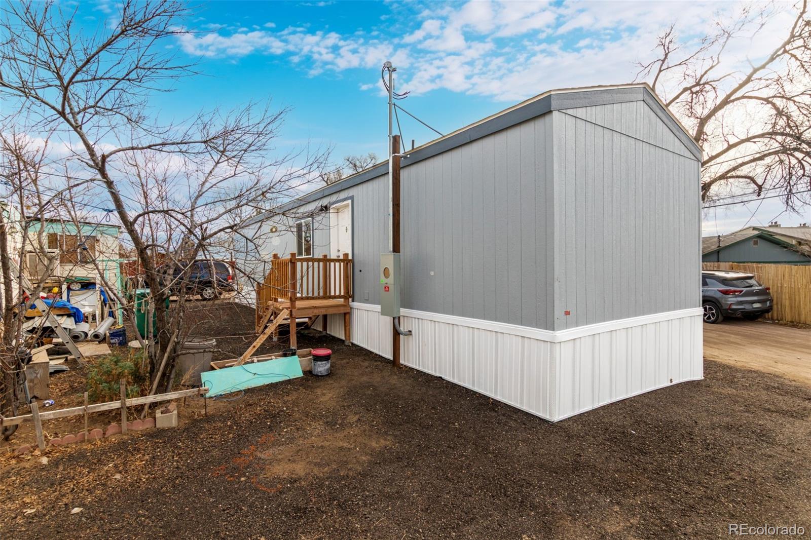 105 Longs Street Brighton, CO 80601 - Photo 24 of 27 a view of backyard with a car parked beside it