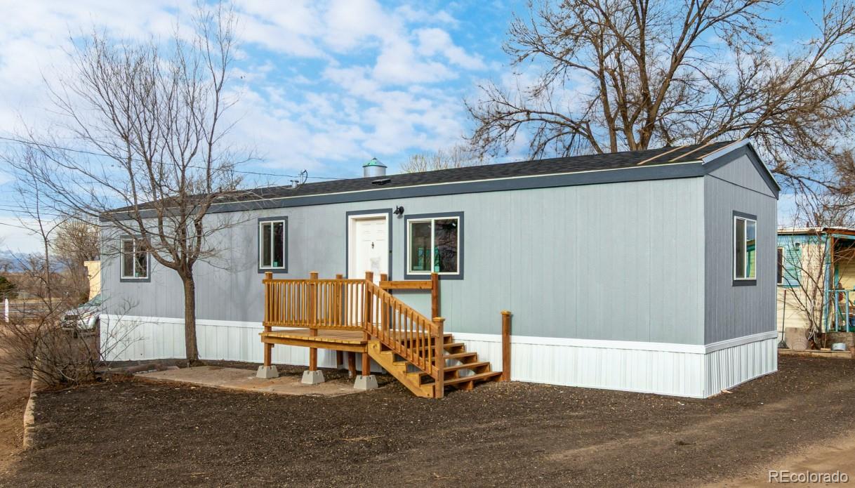 105 Longs Street Brighton, CO 80601 - Photo 4 of 27 a view of backyard with large trees and a couch