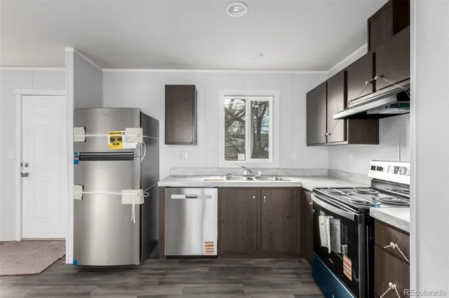 a view of empty room with wooden floor and window