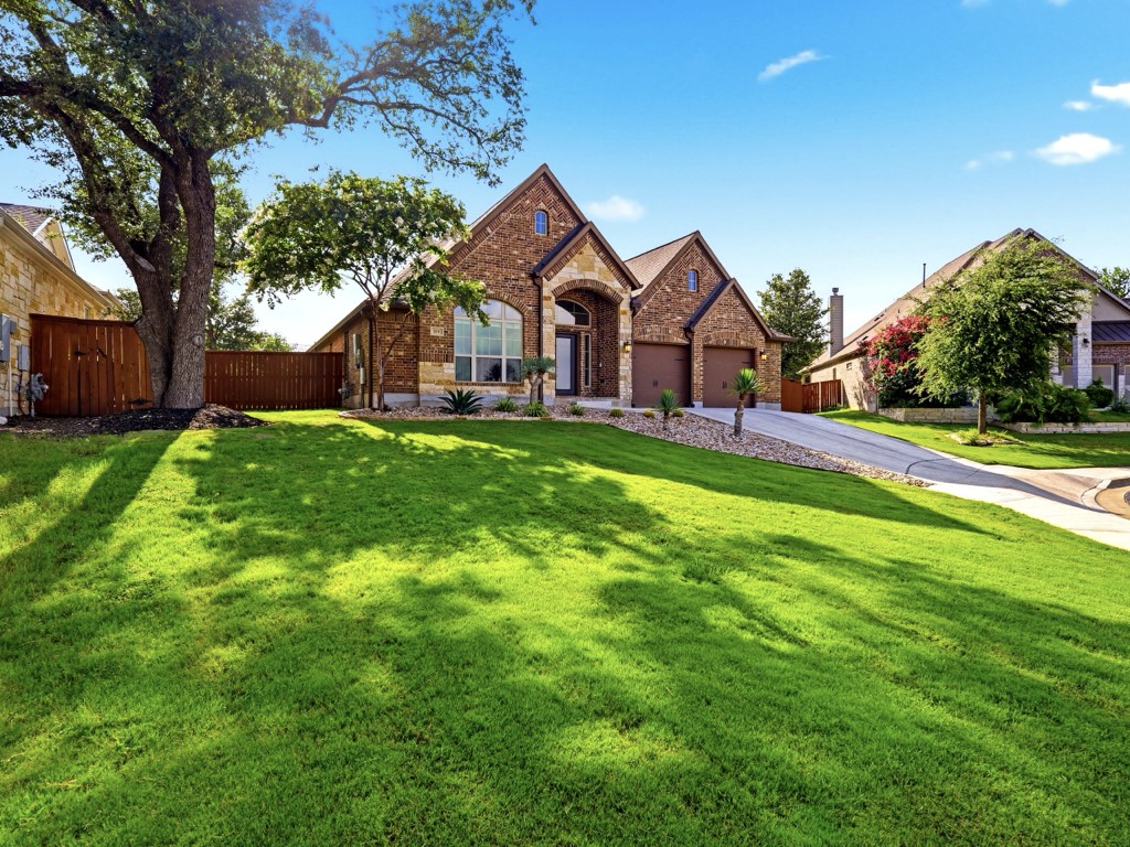 109 Lake Spring Circle Georgetown, TX 78633 - Photo 2 of 38 A well-maintained lawn welcomes you to this attractive brick residence with an attached 2 car garage.