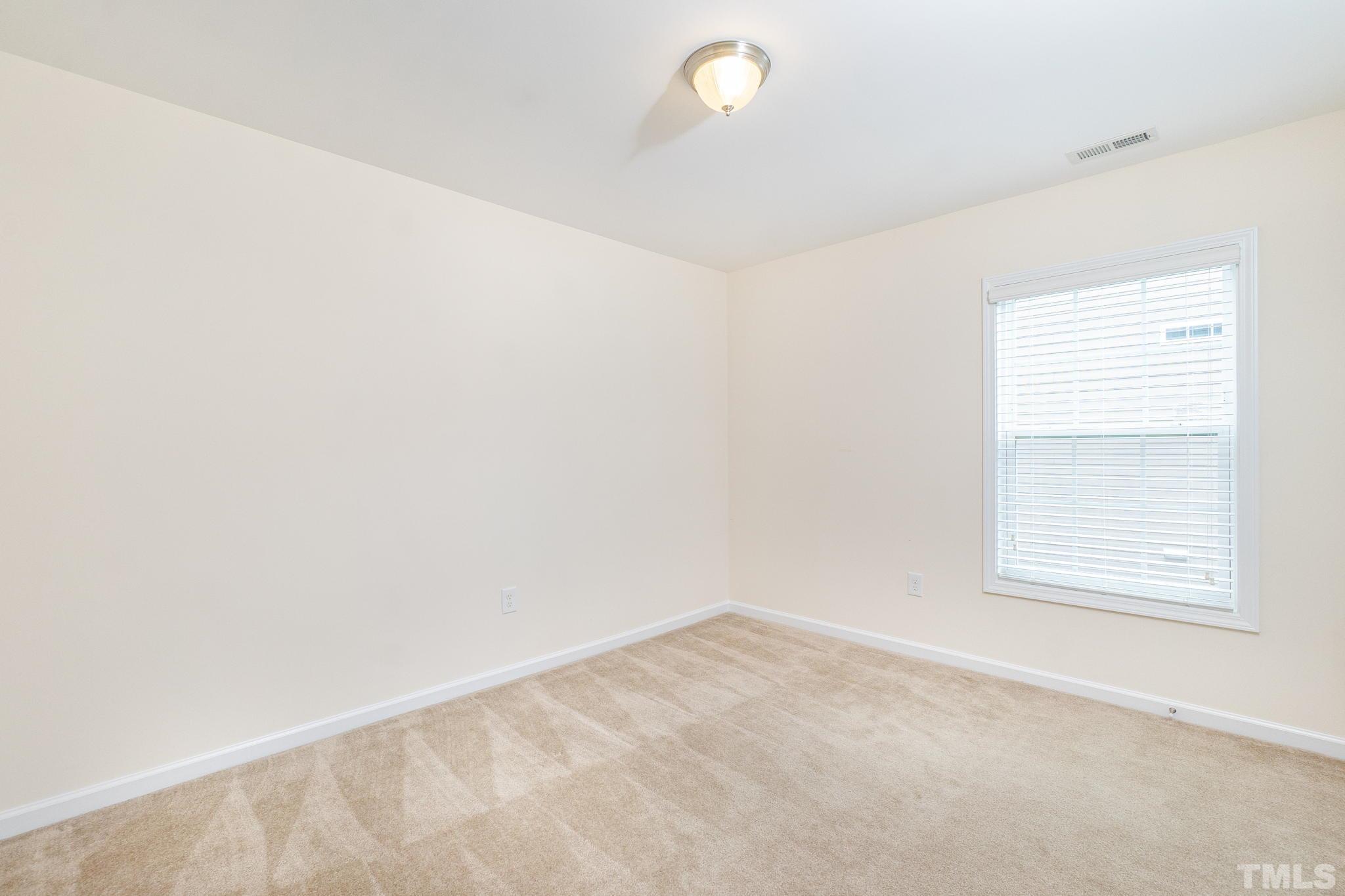 222 Strolling Way Durham, NC 27707 - Photo 18 of 26 an empty room with a window