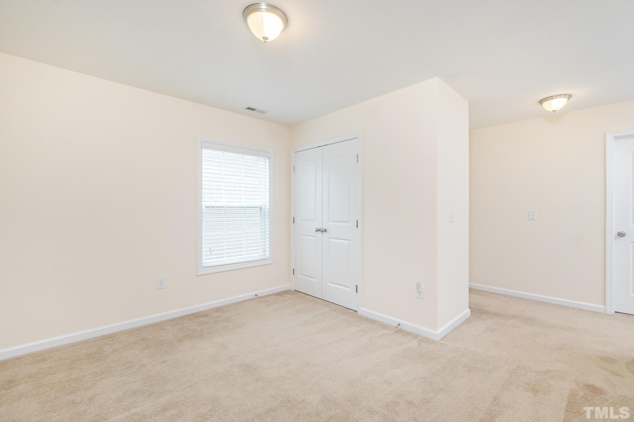 222 Strolling Way Durham, NC 27707 - Photo 19 of 26 an empty room with windows