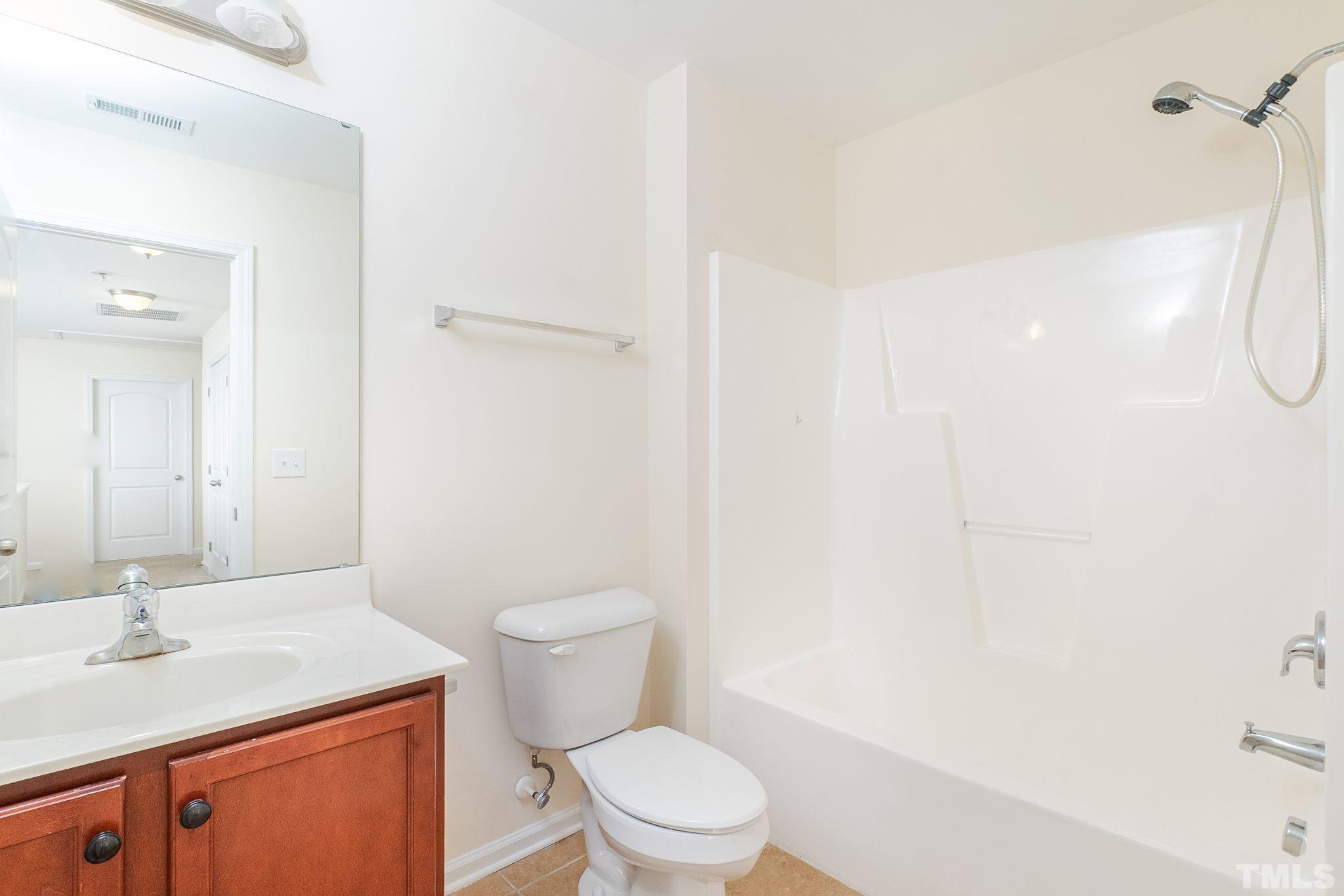 222 Strolling Way Durham, NC 27707 - Photo 20 of 26 a bathroom with a granite countertop sink toilet and shower