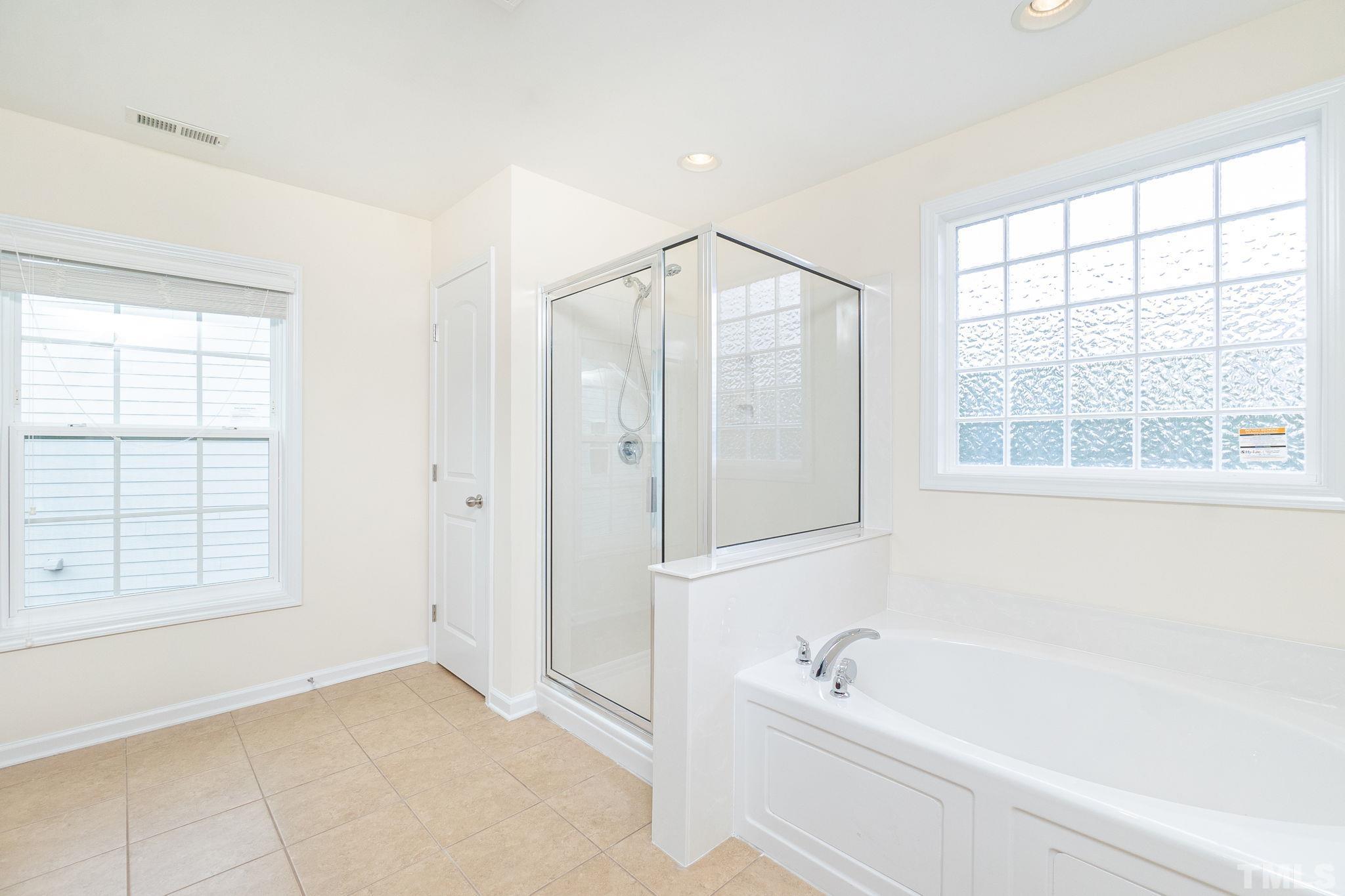 222 Strolling Way Durham, NC 27707 - Photo 24 of 26 a bathroom with a bathtub and a shower