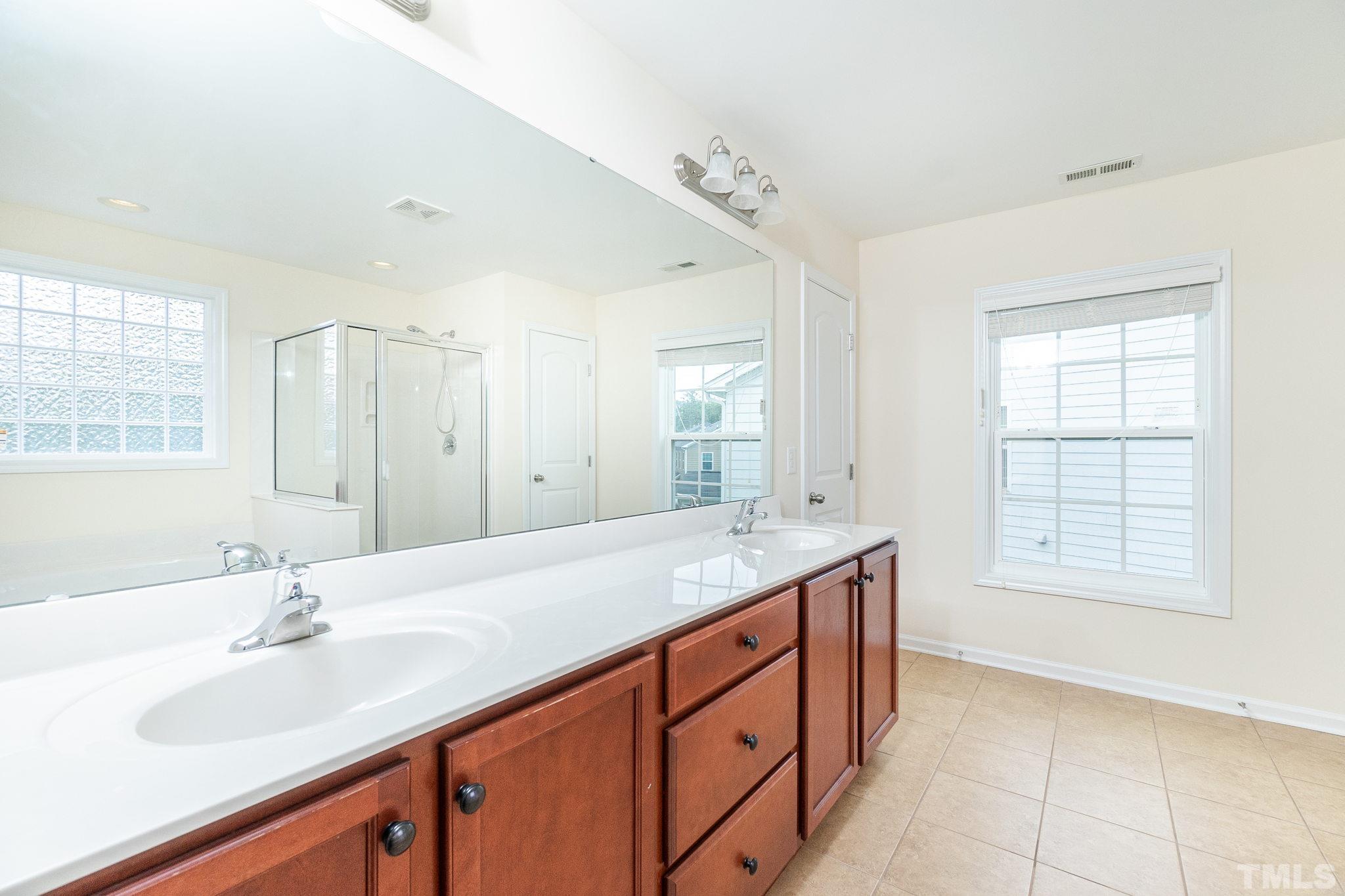 222 Strolling Way Durham, NC 27707 - Photo 25 of 26 a bathroom with double sink and a mirror