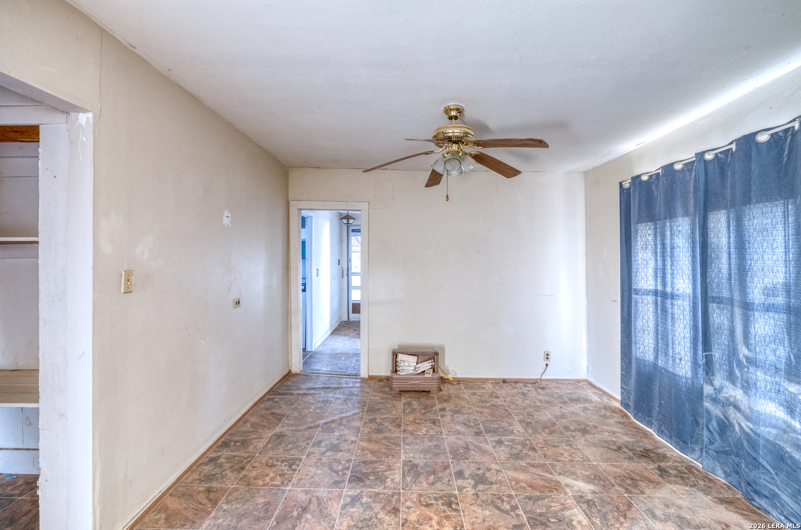 214 Cox Lane Road Carrizo Springs, TX 78834 - Photo 12 of 31 a view of a hallway with a chandelier fan and windows