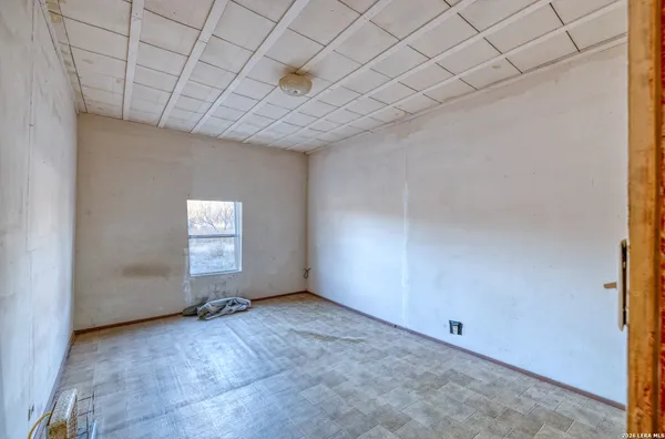 an empty room with a empty space and windows