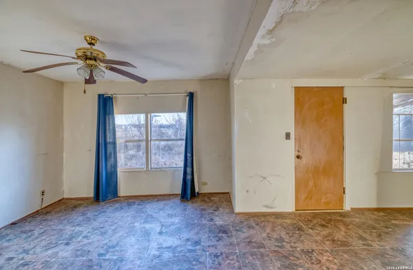 a view of room with window and ceiling fan