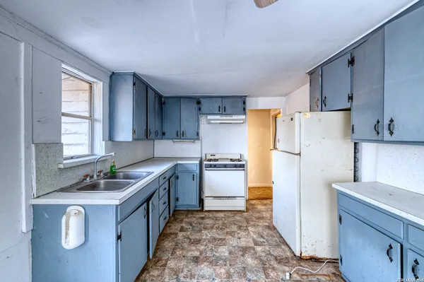 a kitchen with a refrigerator sink and stove