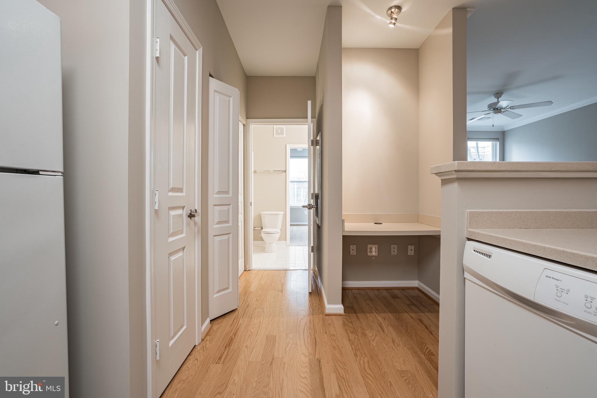 12001 Market Street, Unit 106 Reston, VA 20190 - Photo 12 of 26 a view of a hallway with wooden floor and a bathroom