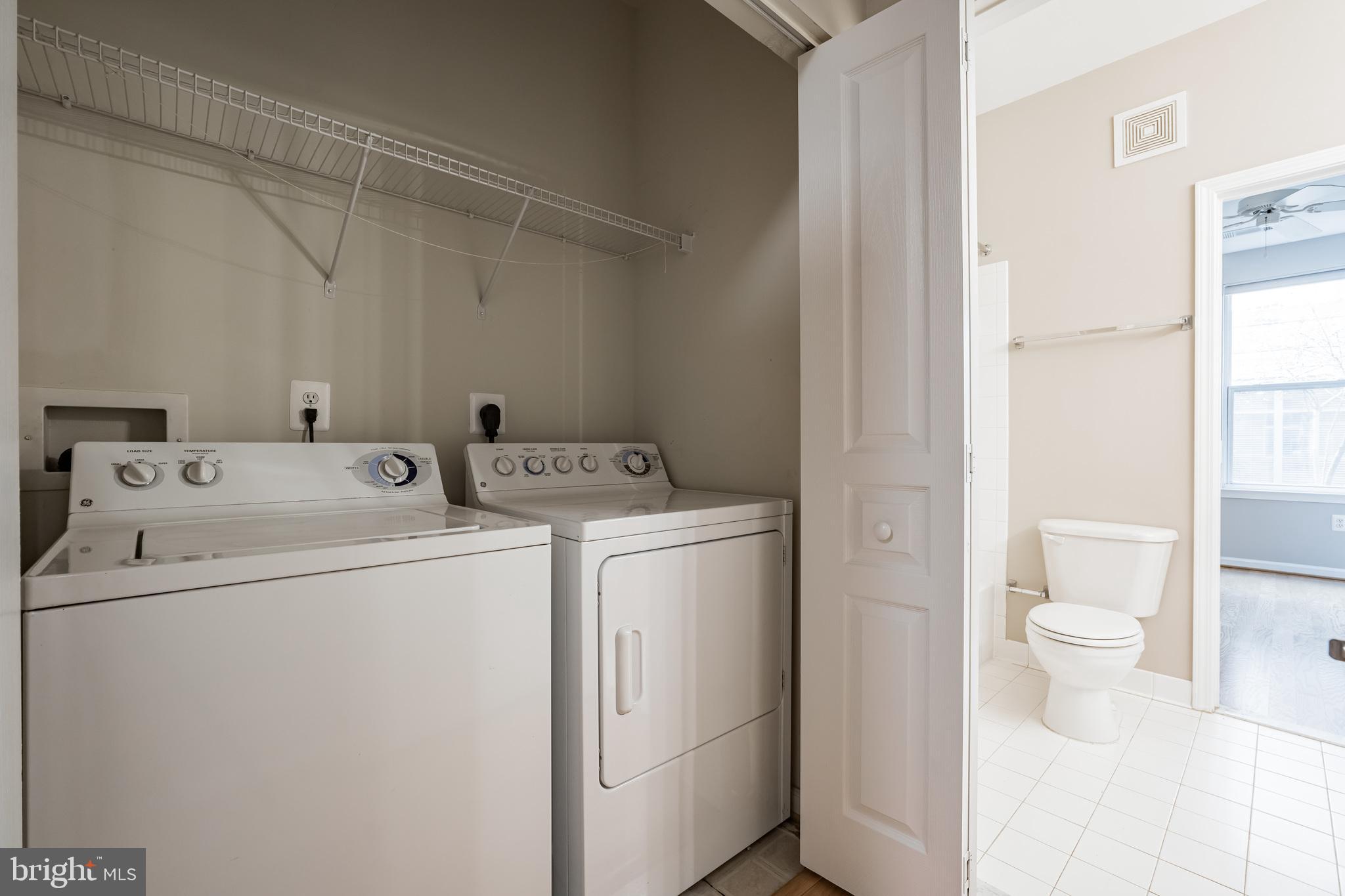 12001 Market Street, Unit 106 Reston, VA 20190 - Photo 13 of 26 a utility room with dryer and washer
