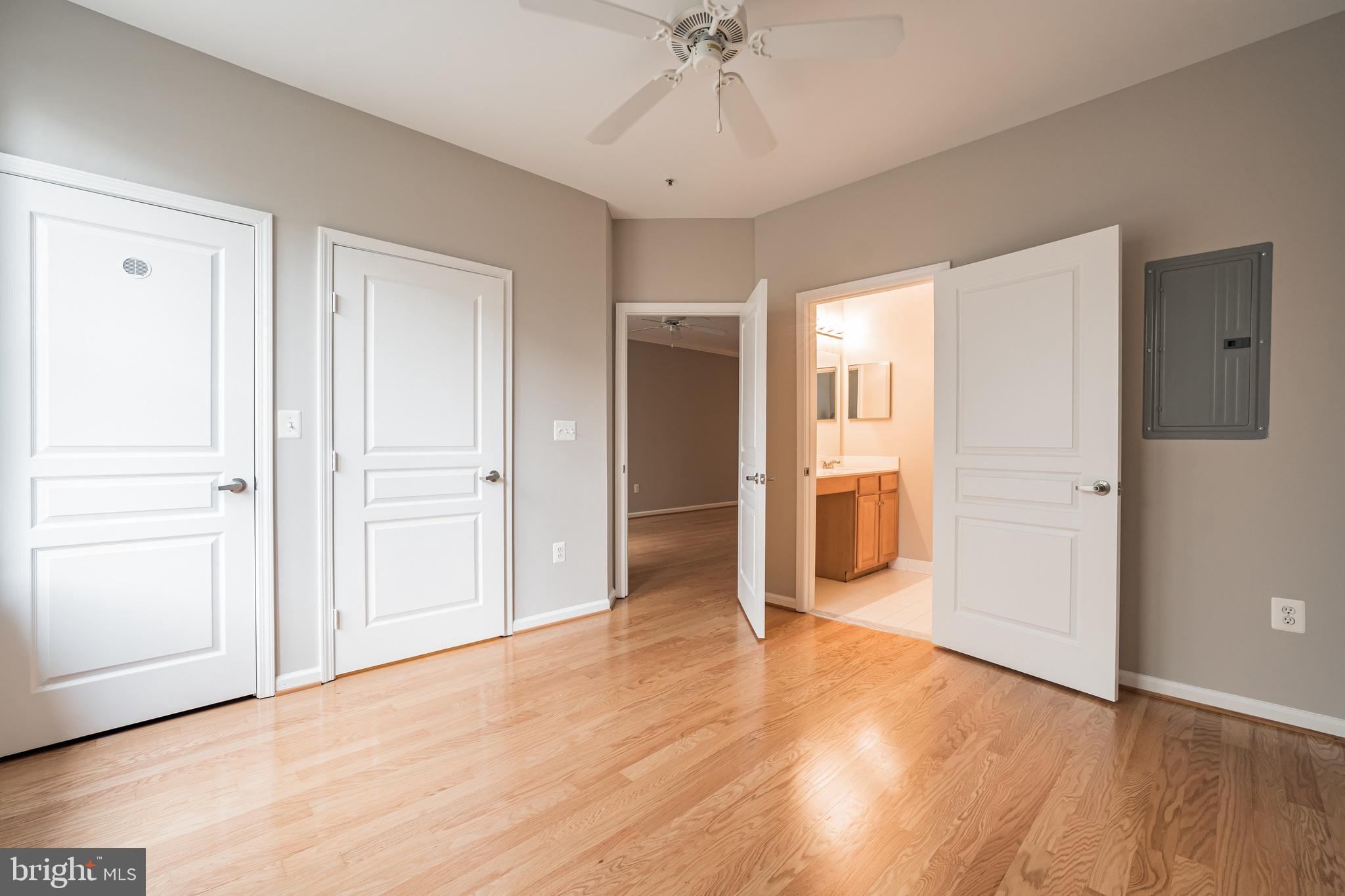 12001 Market Street, Unit 106 Reston, VA 20190 - Photo 15 of 26 a view of a hallway with wooden floor and a bathroom