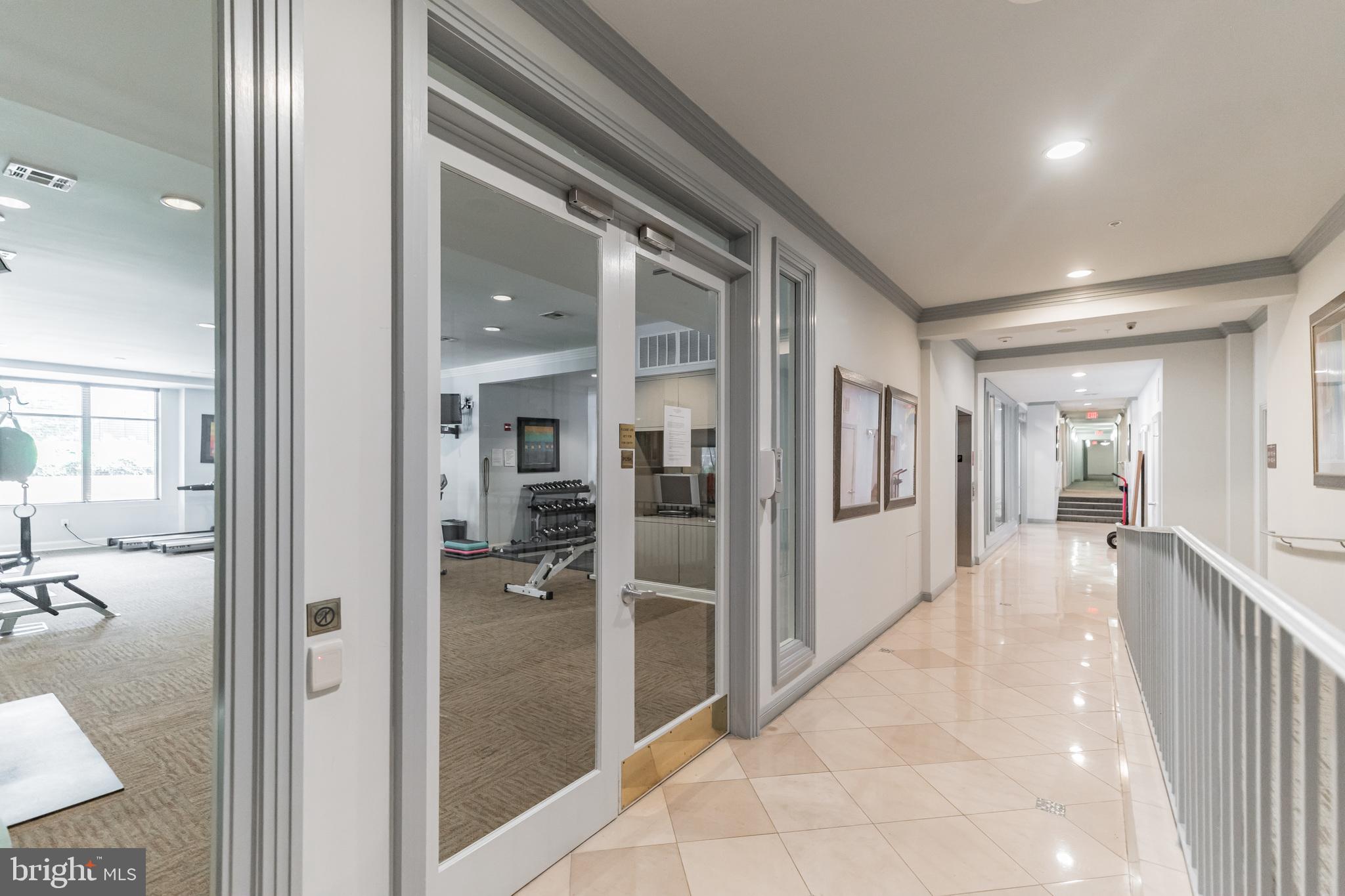 12001 Market Street, Unit 106 Reston, VA 20190 - Photo 20 of 26 a view of a hallway with wooden floor and a bathroom