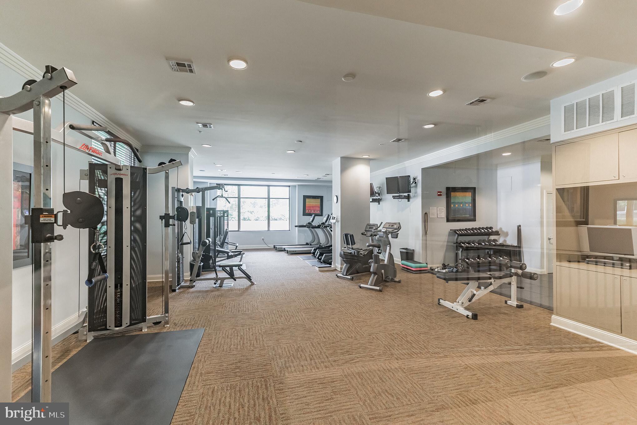 12001 Market Street, Unit 106 Reston, VA 20190 - Photo 21 of 26 a view of a room with gym equipment