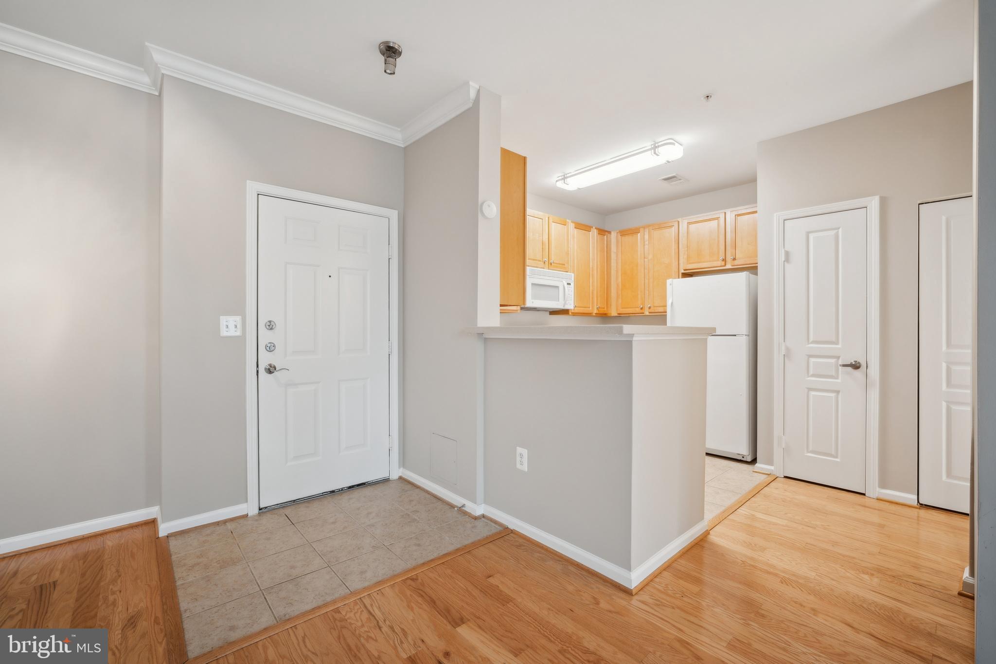 12001 Market Street, Unit 106 Reston, VA 20190 - Photo 4 of 26 a view of a livingroom with a window