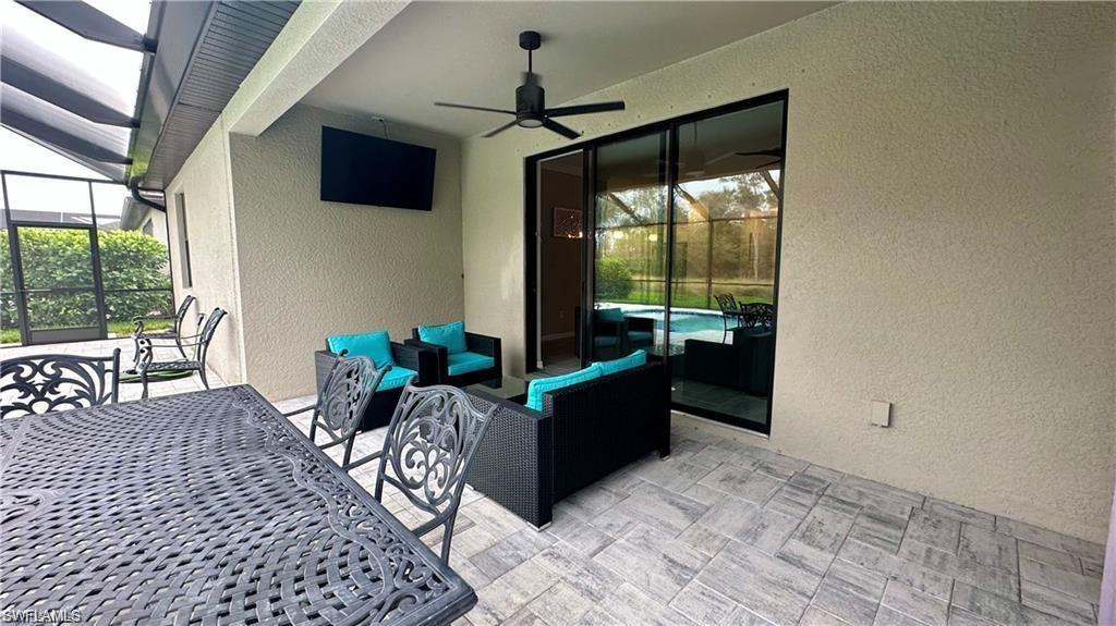 19347 Elston Way Estero, FL 33928 - Photo 17 of 26 View of patio with ceiling fan, an outdoor hangout area, and a lanai
