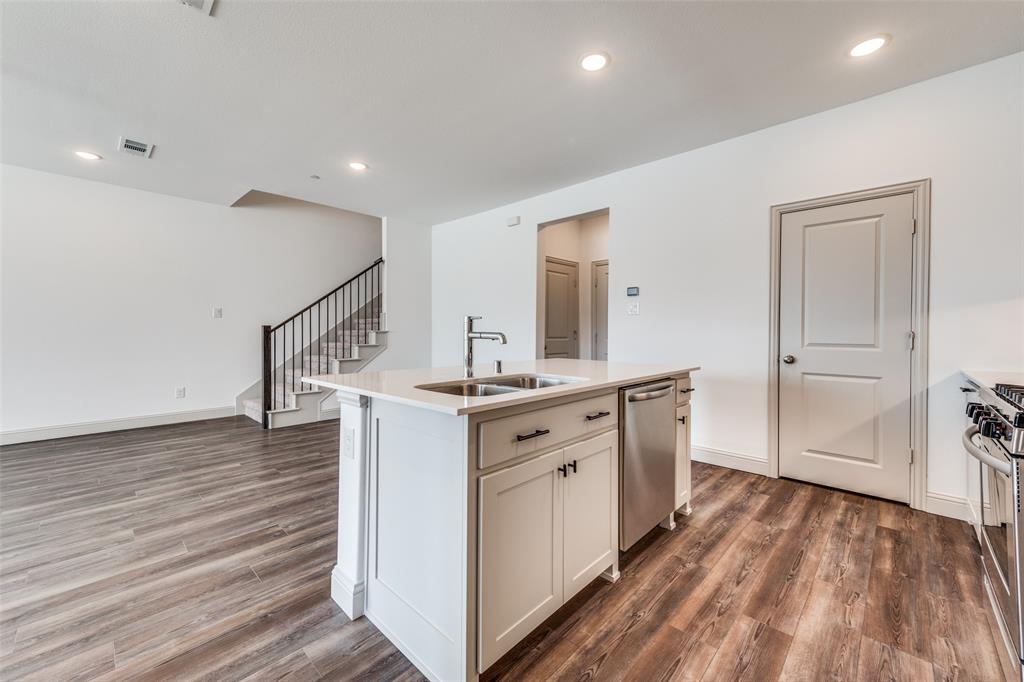 15866 Yellow Elder Road Frisco, TX 75035 - Photo 9 of 25 a kitchen with white cabinets and sink