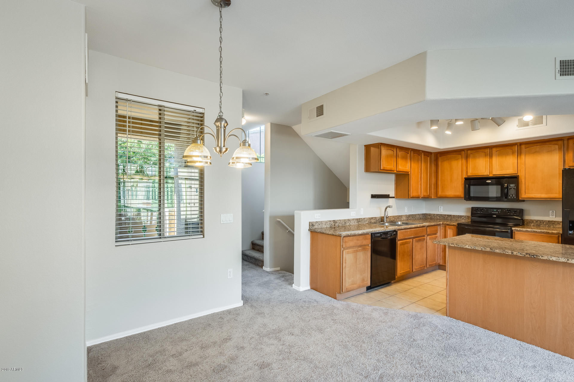 2401 East Rio Salado Parkway, Unit 1124 Tempe, AZ 85288 - Photo 18 of 32 a kitchen with stainless steel appliances granite countertop a stove and a refrigerator