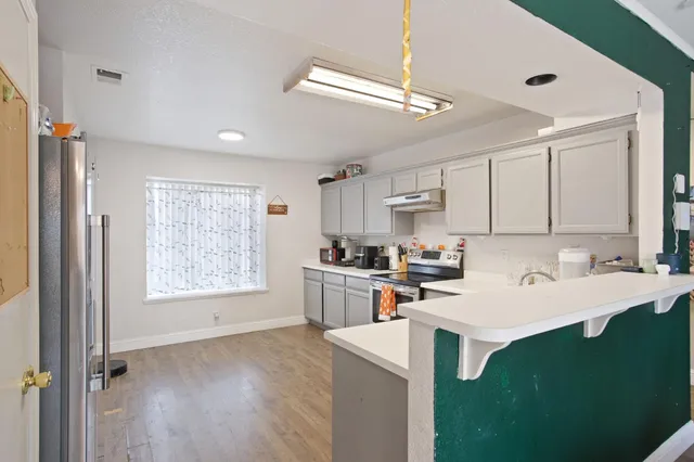 a kitchen with a sink cabinets and window