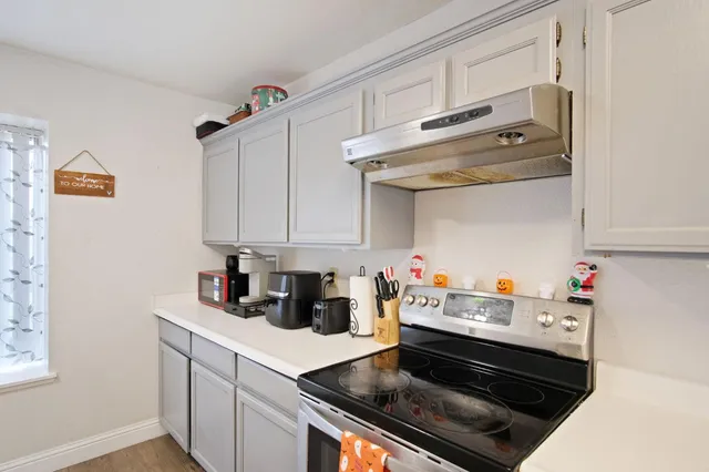a kitchen with a stove and cabinets