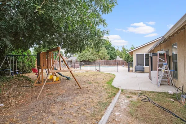 a view of a house with backyard and a slide