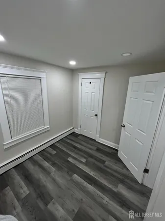 a view of a room with wooden floor and white walls