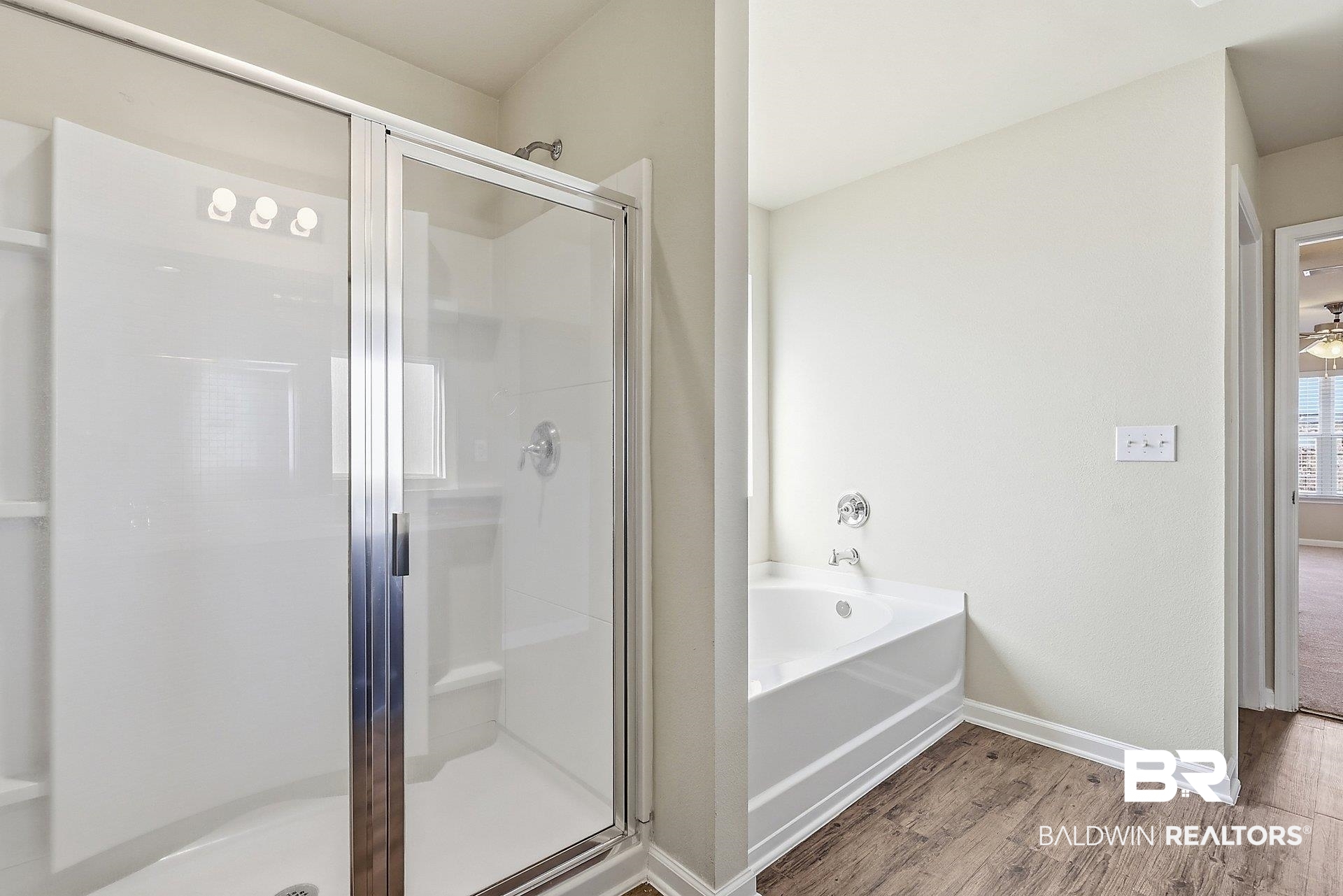 983 Summerton Drive Foley, AL 36535 - Photo 17 of 25 Bathroom featuring a shower stall, a garden tub, and light wood-style floors