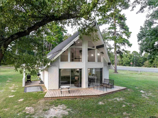 a view of a house with a yard and sitting area