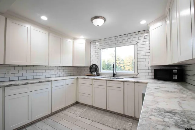 a kitchen with sink and cabinets