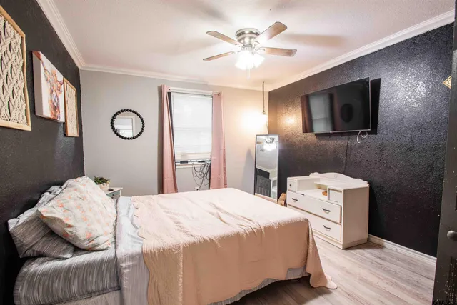 a bedroom with a bed and a television