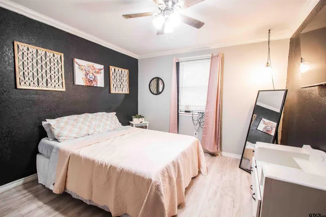 a bedroom with a bed and a mirror