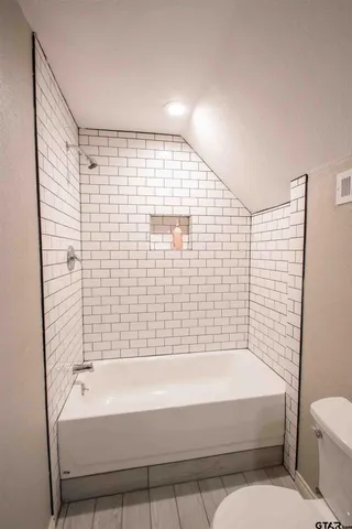 a bathroom with a bathtub and a shower