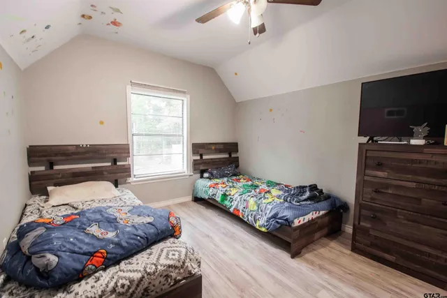 a bedroom with a bed and flat screen tv