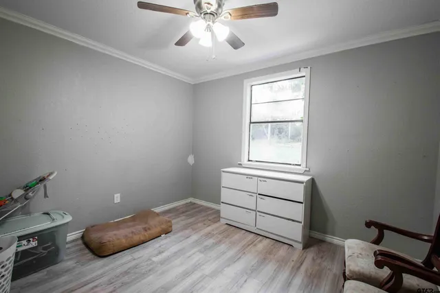 a room with wooden floor and closet