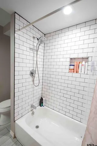 a bathroom with a shower and a sink
