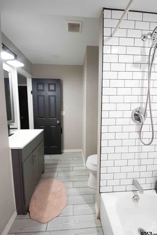 a bathroom with a bathtub and a sink