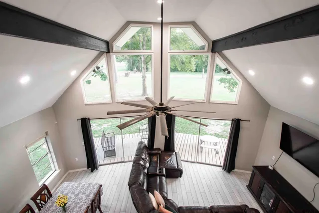 a view of a room with furniture wooden floor and windows