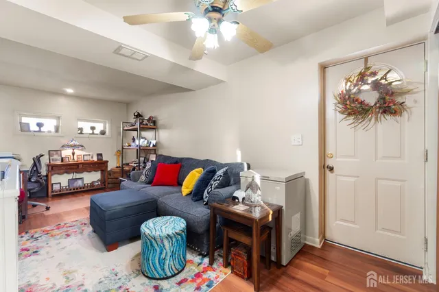 a living room with furniture a rug and a chandelier