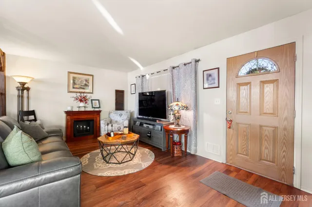 a living room with furniture a fireplace and a flat screen tv