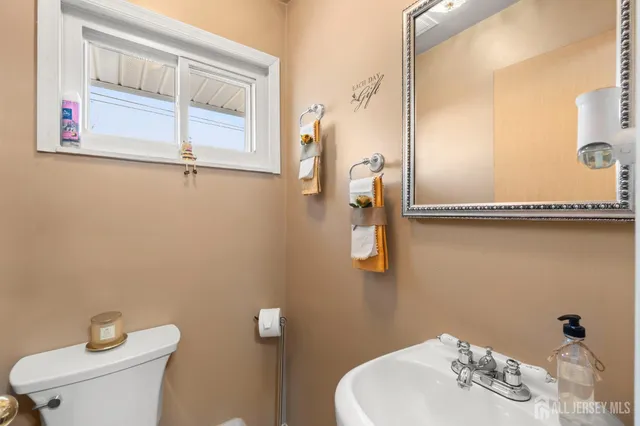 a bathroom with a sink mirror and toilet